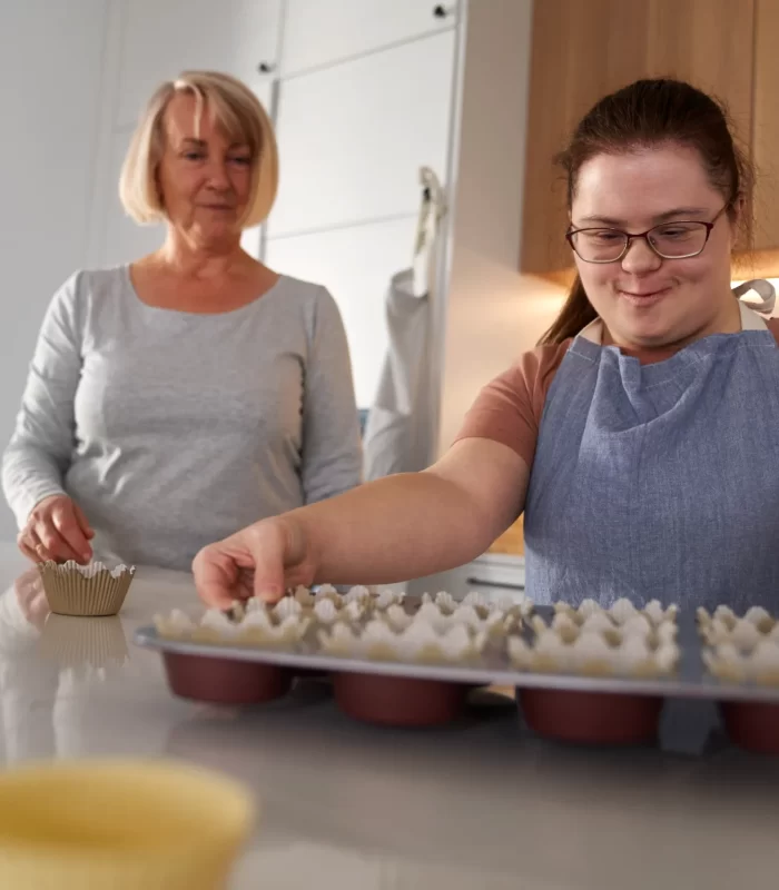 down-syndrome-woman-holding-tray-with-homemade-cup-2024-11-27-13-20-00-utc