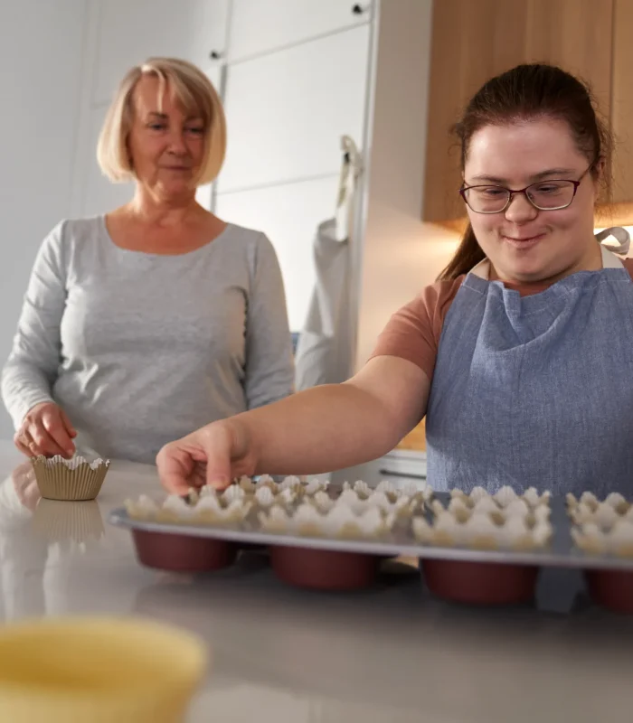 down-syndrome-woman-holding-tray-with-homemade-cup-2024-11-27-13-20-00-utc