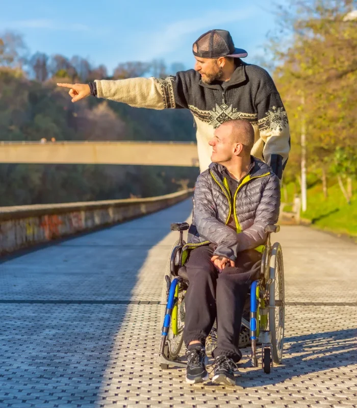 smiling-disabled-person-in-a-wheelchair-walking-wi-2024-12-10-00-28-59-utc